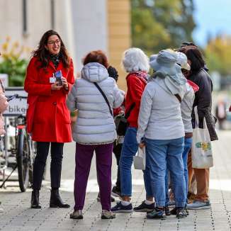 Tourgroep met stadsgids in rode jas tijdens een rondleiding door het centrum van Vaduz in Liechtenstein