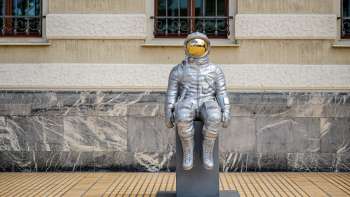 Zilveren astronautensculptuur "Raumableiter" van Max Grüter voor het regeringsgebouw in Vaduz - moderne kunst in de openbare ruimte.