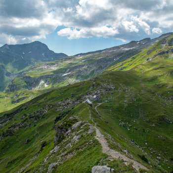 Panoramisch uitzicht over de Pfälzerhütte in de Liechtensteinse Alpen met dramatische wolkenpartijen.
