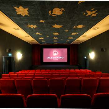 Interieur van het Altes Kino Vaduz met rood fluweel en verlicht scherm