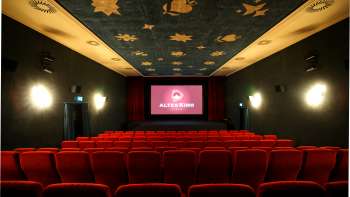 Interieur van het Altes Kino Vaduz met rood fluweel en verlicht scherm
